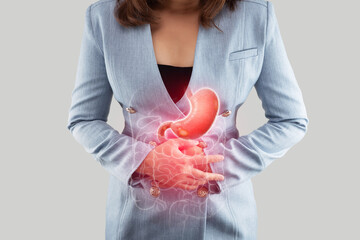 A Woman clutches her stomach, indicating the sharp pain associated with a Gastric ulcer, a common...