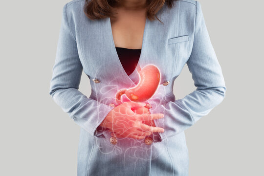 A Woman clutches her stomach, indicating the sharp pain associated with a Gastric ulcer, a common ailment affecting the digestive system.