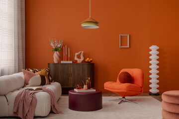 Stylish and cozy interior with white sofa, orange armchair, and sculptural decor on a wooden...