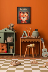 Fototapeta na wymiar Stylish colorful child room with wooden desk, decorations, toys and mock up poster frame.