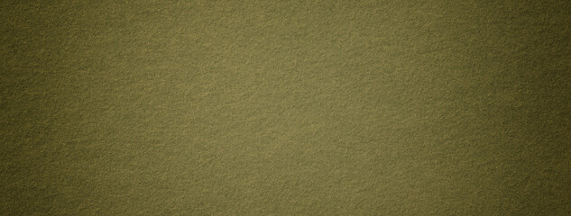 Texture dark green background from felt textile material with vignette, macro. Structure vintage olive fabric cloth