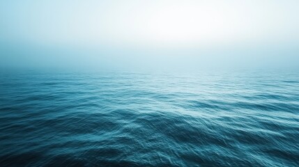 Obraz premium Serene ocean horizon under soft blue sky at sunrise