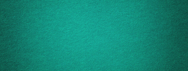 Texture dark green background from felt textile material with vignette, macro. Structure vintage...