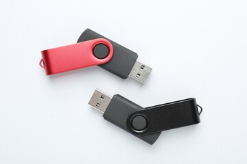 Flash drives on white background, flat lay