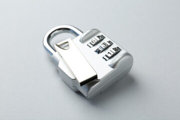 Flash drive and combination padlock on light background, closeup