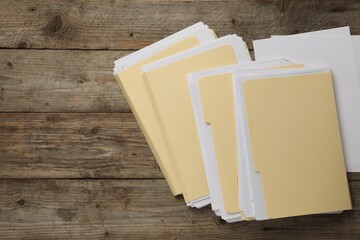 File folders with papers on wooden table, flat lay. Space for text