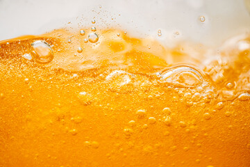 Close up bright orange Oil or beer splash texture and nature waves, Beautiful waves curve and...
