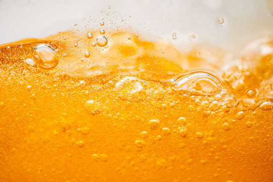 Close up bright orange Oil or beer splash texture and nature waves, Beautiful waves curve and little bubbles smooth for graphic design and background, Oil Bubbles, Soft beer bubbles, Selective focus