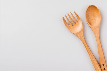Wooden spoon and fork on a light gray background