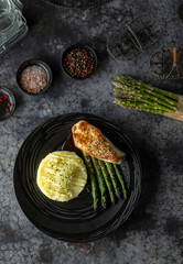 Sesame crusted chicken breast served with mashed potatoes and asparagus