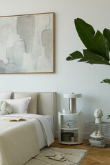 Modern bedroom detail with abstract wall art, lush green plant, and artistic accessories.