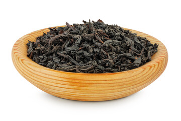 Dry black tea leaves in wooden bowl isolated on white background