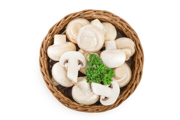 Fresh mushroom champignon in a wicker basket isolated on white background. Top view. Flat lay.