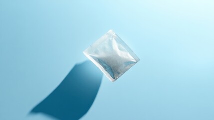 Tea bag on a pale blue background with a subtle shadow beneath it, floating in the center --ar 16:9 --stylize 250 --v 6.1 Job ID: 815dc579-d9bd-4883-ae1e-e3a55b56b335