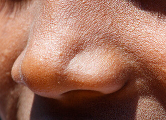 Fototapeta premium A close up of a person's nose with a slight frown
