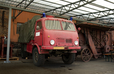 Fototapeta premium Old military vehicle. Military truck with blue beacons on the roof of the cabin. Parked truck. Car bed with tarpaulin.