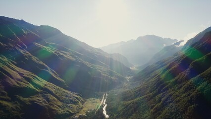 Panoramic shot from a bird's eye view, a view of the mountain valley in the rays of the rising sun....