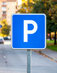  Blue Square Parking Sign in Urban Setting with Meter and Attendant