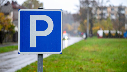  Blue Square Parking Sign in Urban Setting with Meter and Attendant