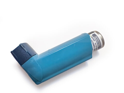 Calgary, Alberta, Canada. Apr 29, 2025. A teal Sanis Salbutamol HFA inhalation aerosol inhaler with a dark blue cap rests diagonally on a white surface. The label is partially visible.
