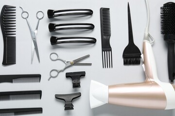 Fototapeta premium Different hairstyling tools on white background, flat lay