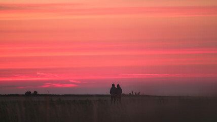 Stunning sunset silhouettes lovers embrace nature's fiery hues breathtaking beauty