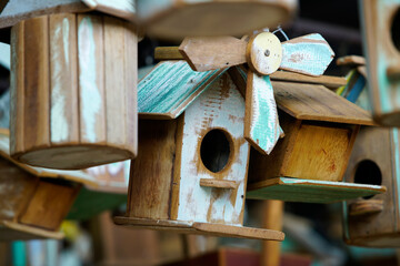 Colorful wooden birdhouses with unique designs hanging outdoors