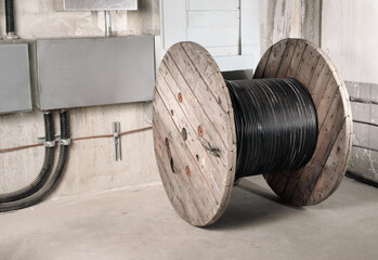 Fiber optic wooden cable reel in electrical room. Large 1000m loose tube cable wood drum....