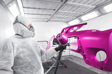 Spraying the paint to the car element. Paint coating business.