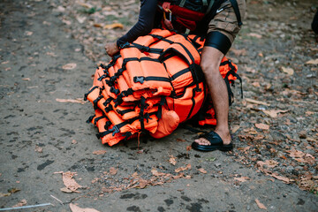 Man preparing safety equipment for rafting adventure experience