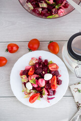 Healthy salad with mozzarella and beetroot, served on a wooden surface