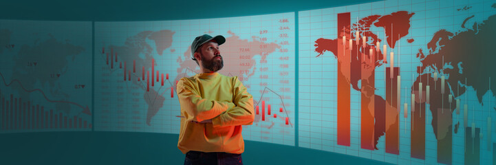Man observing global financial statistics on digital wall with red bar charts showing economic decline. Concept of business, graphics, economy, stock, market trends, data analysis.