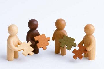Cultural diversity and inclusive workplace shown by authentic representation with wooden figures holding puzzle pieces together