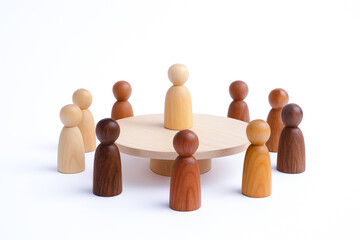 Cultural diversity and inclusive workplace shown by authentic representation of wooden figures in various shades around round table