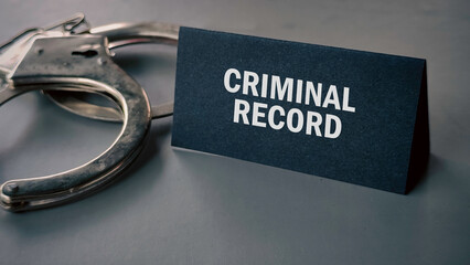 handcuffs with tag written Criminal record.