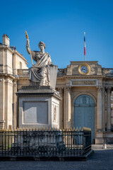 Obraz premium Paris, France - 04 18 2025: View of the National Assembly from Place du Palais Bourbon with its statue of Law.