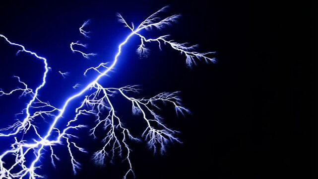 Electric lightning strikes against black background showing raw power and natural phenomena