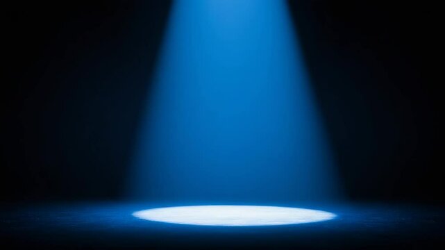 Blue Spotlight on Empty Stage - A dark blue stage is illuminated by a single spotlight from above, creating a dramatic and mysterious atmosphere. The light casts a subtle glow on the floor