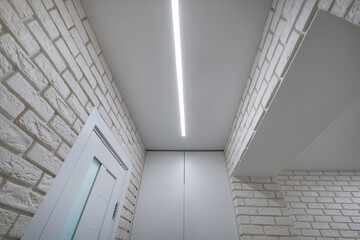 suspended ceiling with halogen spots lamps in form of squares and rectangles and drywall...