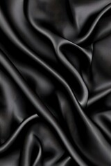Obraz premium Elegant black satin fabric with soft folds and subtle texture creating a luxurious and sensual visual experience for fashion and design projects