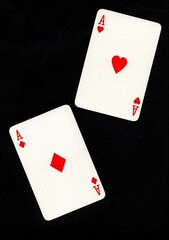 A pair of playing cards of the same value isolated on a black background.