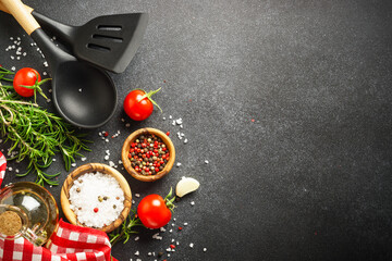 Food background on black. Fresh herbs, spices and vegetables with tablecloth.