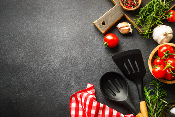 Food background on black. Fresh herbs, spices and vegetables with tablecloth.