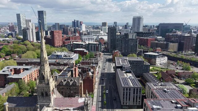 Salford skyline with urban greenery, traffic and Cathedral Church of St John the Evangelist