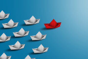 Group of white paper ship in one direction and one red paper ship pointing in different way on blue background. Business for innovative solution concept.