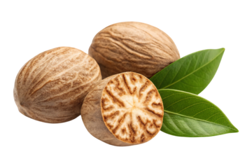 Aromatic nutmeg seeds one halved with vibrant green leaves