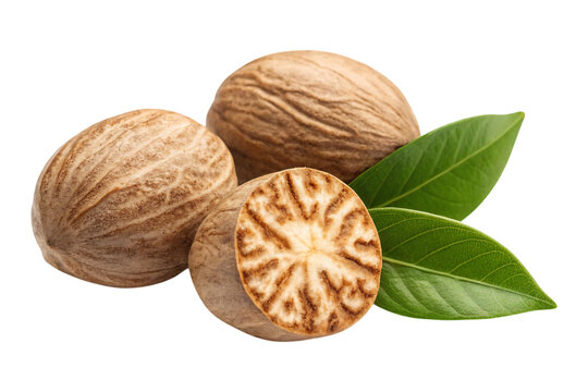 Aromatic nutmeg seeds one halved with vibrant green leaves