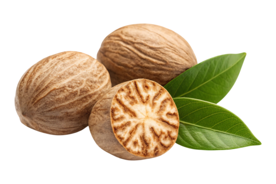 Aromatic nutmeg seeds one halved with vibrant green leaves