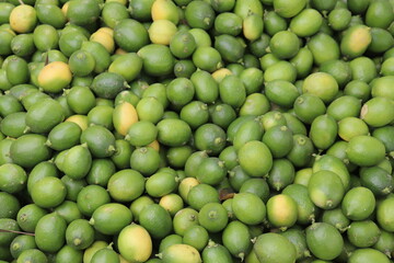 Heap of Fresh Raw Green Limes Texture, Full Shot, Vibrant Citrus Fruit