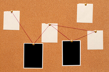 Blank paper notes and an empty photo are pinned to a cork board. The concept of detective...